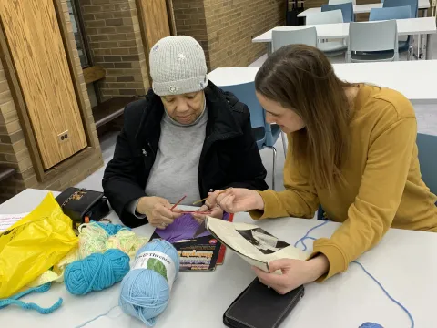 A Librarian (not SHPL) assisting with crocheting 