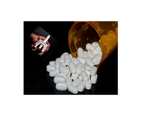bottle of spilled pills with hand holding Narcan nasal spray